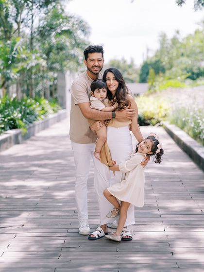 A classic family portrait on a wooden walkway. Even in a more posed shot, I aim for natural expressions and connection.