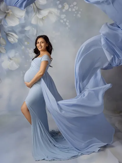 Another stunning fabric toss, with the blue gown appearing to fly around her, creating a sense of weightless grace.