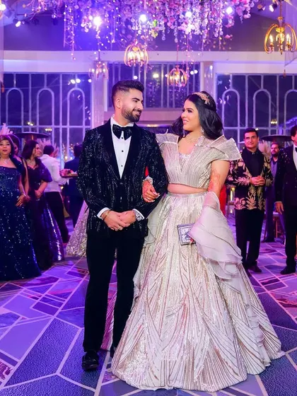 From the grand ballroom to the dance floor, we capture the high-energy atmosphere of your reception. This image showcases the couple's stylish outfits and the celebratory mood, reflecting our versatility in covering glamorous evening events.