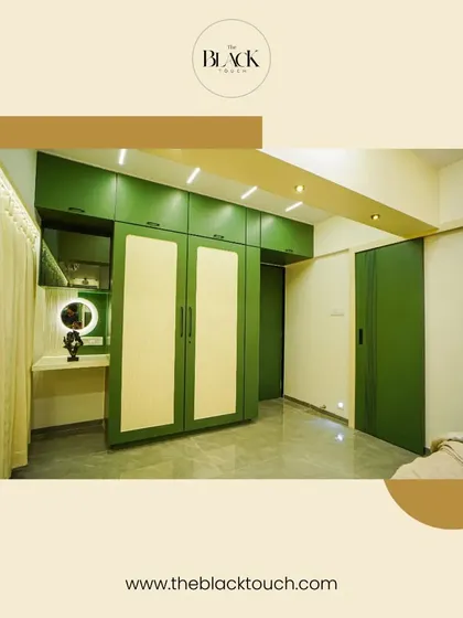 A bedroom wardrobe and vanity unit in a refreshing green and cream color combination. The design is both functional and visually appealing.