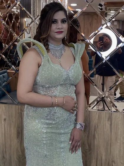 A modern and edgy party look. This client is wearing a structured silver gown, and we gave her a bold smokey eye and a sleek hairstyle to match.