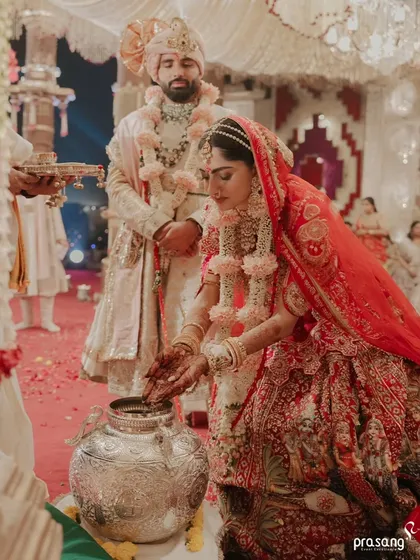 Every ritual is given its due importance. Here, the bride performs a traditional ceremony, and my planning ensures that every element, from the ornate silver pot to the couple's positioning, is perfectly arranged for both meaning and photography.