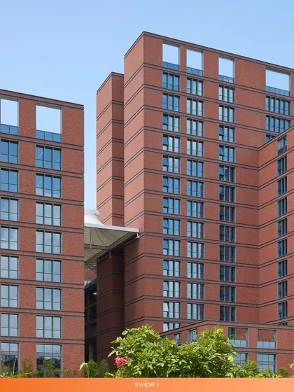 A detail of the brick-clad towers at the Wipro Hyderabad campus. The use of earthy terracotta on the facade, combined with self-shading massing, helps the building breathe with its environment and perform efficiently in Hyderabad's tropical climate.
