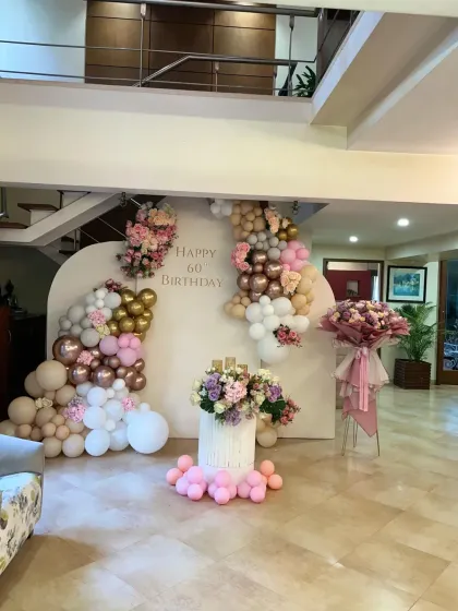 A wide view of the elegant 60th birthday decor I set up with less than a day's notice, featuring a beautiful floral and balloon arrangement.