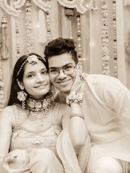 A fun and happy portrait of a brother and sister at the Haldi. Their cheerful expressions make this a lovely, candid family photo.
