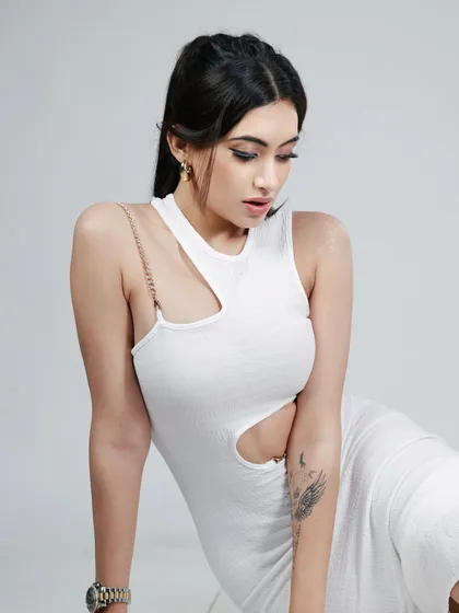 A downward-looking pose from the same series, creating a contemplative and elegant mood.