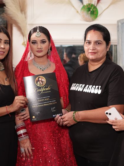 Presenting a certificate to a student in her beautiful red bridal creation.