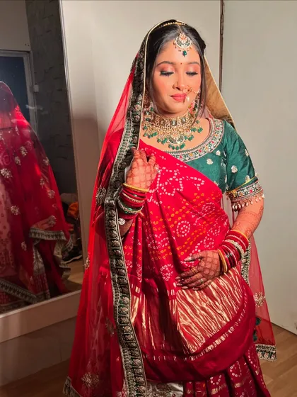 My beautiful Gujarati bride Gauri, her red bandhani dupatta adding a traditional touch to her green and red lehenga.