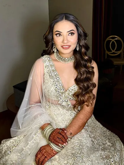 This sangeet bride opted for an ethereal look in a white mirror-work lehenga. I complemented it with soft, romantic makeup and beautiful, flowing curls.