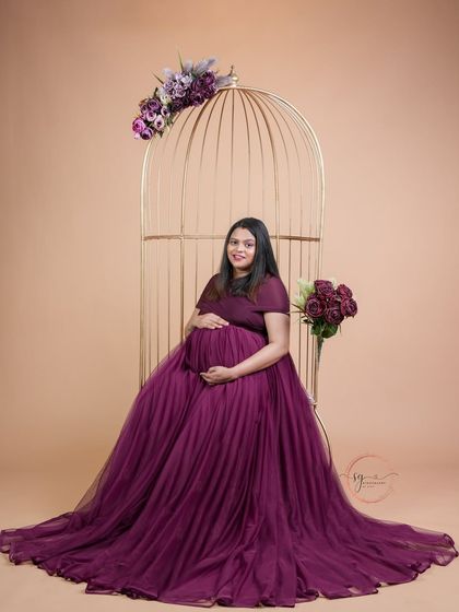 An elegant seated portrait in our golden birdcage. The rich purple gown drapes beautifully, creating a regal and timeless image.