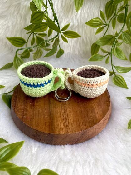 A pair of coffee cup keychains.