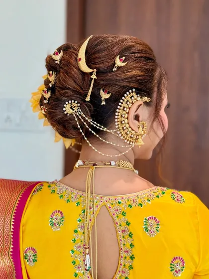 A close-up of the traditional Khopa hairstyle, adorned with a chandrakor and floral accessories. This classic bridal updo is a signature part of my Maharashtrian bridal service.