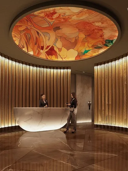 The reception area at Palais Royale features a sculptural marble desk and a dramatic ceiling fresco. The design uses curved walls and warm lighting to create a ceremonial sense of arrival, upholding the ethos of understated grandeur.