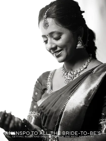 A black and white portrait of a bride-to-be, capturing her gentle smile and the details of her attire.