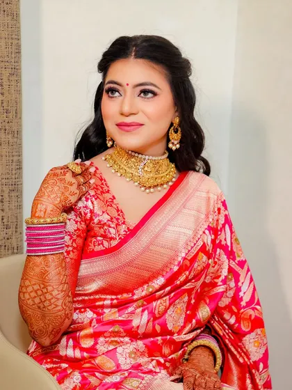 A close up of the bride, showing her soft makeup and the beautiful texture of her silk saree.