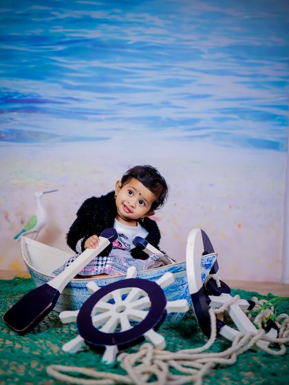 Explore our full nautical and beach-themed collection. These images showcase the variety of poses and angles possible with our boat prop, sand-colored flooring, and ocean backdrop.