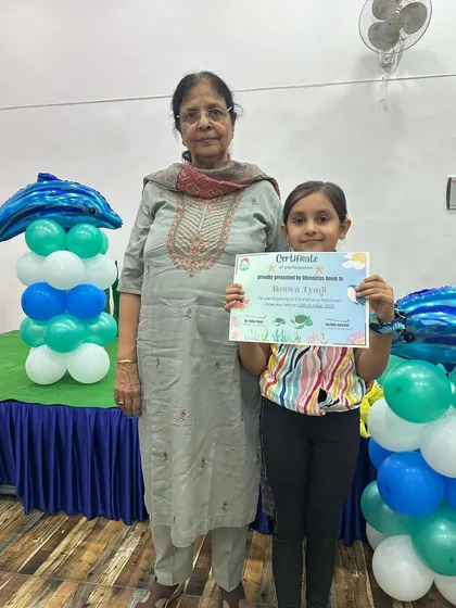 Another happy student with her grandmother, holding her certificate of achievement. It's wonderful to see grandparents encouraging their little ones.