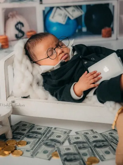 This little boss baby is dreaming of his next big merger. The tiny laptop and money bags make this 3-month-old shoot so much fun.