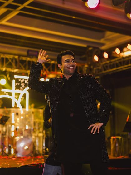 A stylish portrait of the groom during his sangeet dance, showcasing his smooth moves and happy vibe.