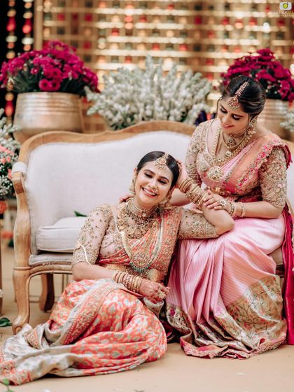 Another beautiful portrait of sisters, showcasing their coordinated sarees and the strong bond they share.