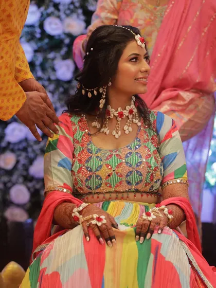 A candid shot of the bride during her Haldi, her makeup staying flawless throughout the fun and festivities.