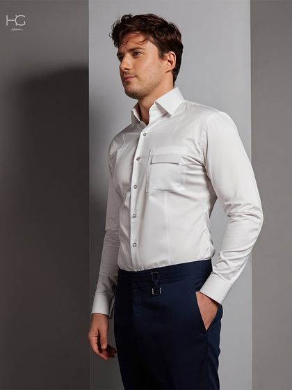 Timeless sophistication in every stitch. This white shirt features a unique pocket detail, adding a touch of modern utility to a classic formal piece.