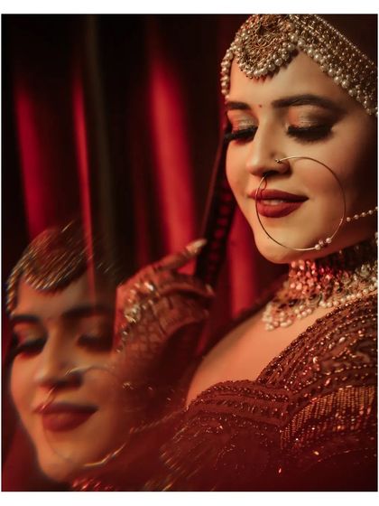 A creative, double-exposure shot of Vanshita, her smiling reflection adding a dreamy and artistic layer to the portrait.