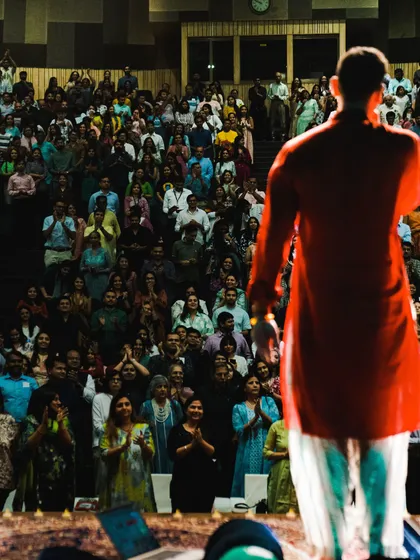 Standing to thank the incredible audience in Ahmedabad. Their energy and participation are what make these events so powerful and transformative for everyone involved.