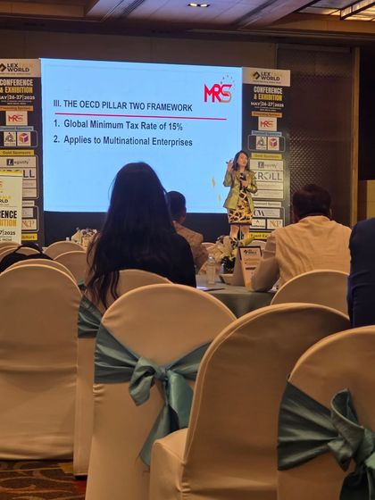 A speaker at the LexTalk World Conference discussing the OECD Pillar Two framework. Staying informed on global regulatory changes is crucial for providing top-tier legal advice.