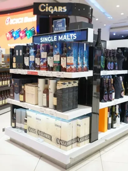 A close-up of a single malts and cigars display. We focus on clear labeling and attractive product arrangement, ensuring every detail is sharp and legible for commercial use.