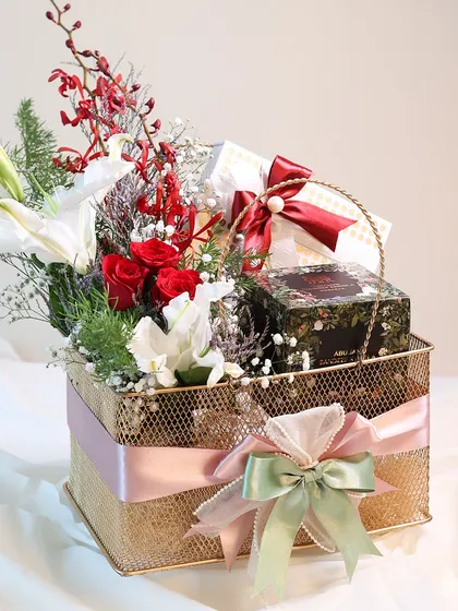 The complete golden basket hamper, beautifully tied with multiple ribbons. It’s a gift that is both indulgent and thoughtfully put together.