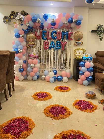A 'Welcome Baby' decoration with a mix of blue, pink, and silver balloons against a shimmer wall. This setup is perfect for a gender-neutral or twins celebration.