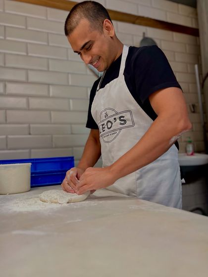 Here I am, getting hands-on with the dough. This is my happy place. The feel of the dough tells you everything you need to know about the pizza you're about to create.