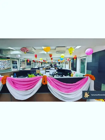 We decorated the office cubicles with pink and white fabric swags, marigold garlands, and colorful paper lanterns. This simple touch brings the festive celebration to every corner of the workspace.