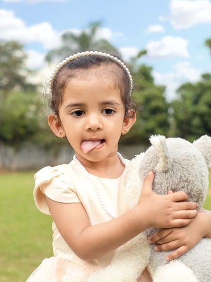 A fun outdoor session with three sisters. I love capturing the natural light and genuine interactions of children playing together in a park setting.