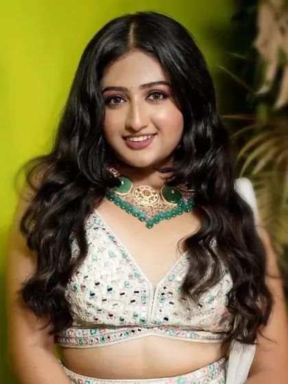 A close-up of the model, her smile lighting up the frame.
