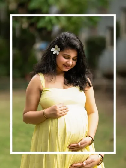 A lovely close-up portrait of an expecting mother outdoors. The flower in her hair adds a delicate touch to this natural and beautiful shot.