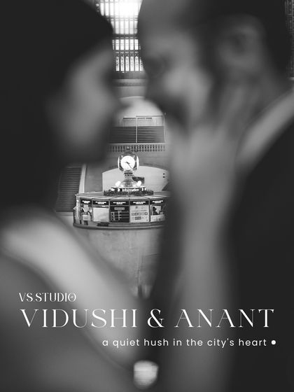 An artistic, moody shot of a couple at Grand Central Station, with the iconic clock in the background. The black and white edit and shallow depth of field create a sense of intimacy amidst the bustling city.