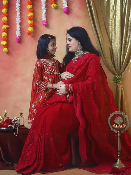 A mother's love, reflected in her daughter's eyes. This sweet photo captures the connection between them as they both celebrate the baby on the way in a traditional setting.