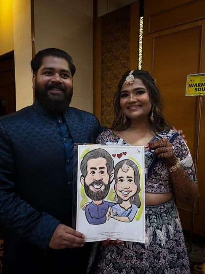 A lovely couple at their reception, delighted with their custom caricature. These portraits are a great way to remember the fun of the event.