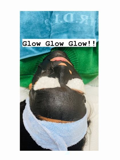 The "Glow Glow Glow" says it all. This is the carbon mask application step, preparing the skin for deep purification and rejuvenation.