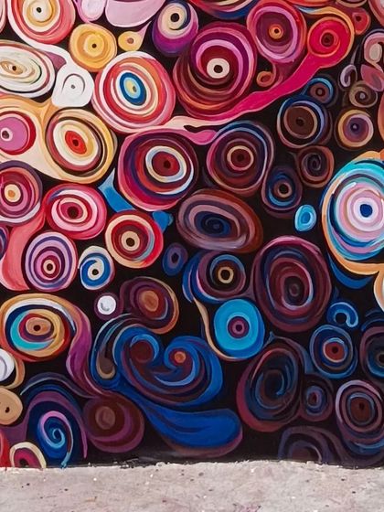 The bottom edge of the abstract mural, showing the density of the hand-painted details.