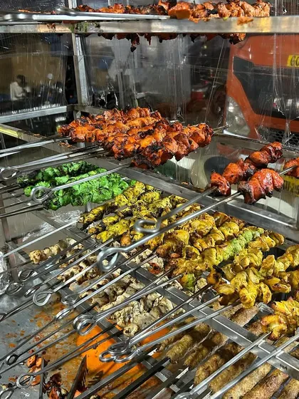 Our tandoor station in full swing, showcasing a colorful variety of freshly grilled kebabs. You can see skewers of Malai Tikka, Hariyali Tikka, and classic Tandoori Tikka, all ready to be served hot and smoky.