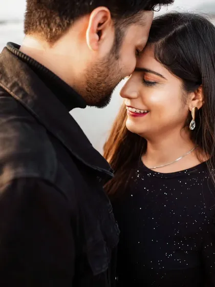 The gentle touch and shared smile in this close-up portrait show the couple's easy comfort with each other. These are the authentic interactions I aim to capture during our session.