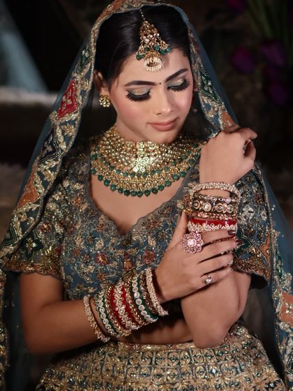 A close-up of the bride's hands and bangles, a shot that captures the small, important details.