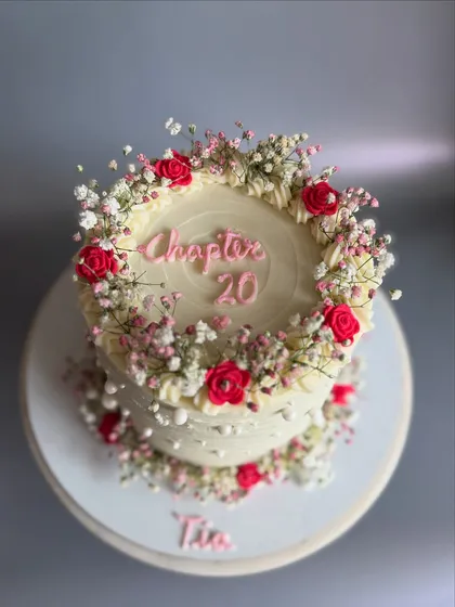 A top-down view of the 'Chapter 20' cake, showcasing the beautiful floral wreath design. This style is perfect for sweet 16s, 18ths, and 20th birthdays.