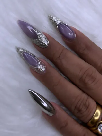 Another angle of the purple and chrome stiletto nails, showing the sharp, clean shape and the beautiful contrast between the glossy purple and metallic silver.