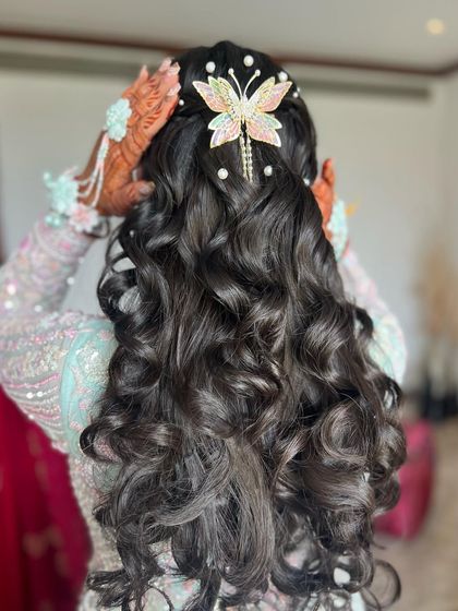 Another angle of the butterfly and pearl hairstyle, showing how the accessories are placed to create a dreamy look.