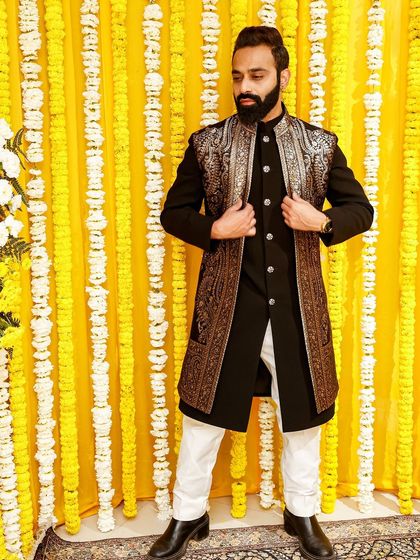 For your best friend's wedding, make sure you shine. This guest wears a stunning black Indo-Western outfit with a heavily embroidered gold jacket, a true statement piece.