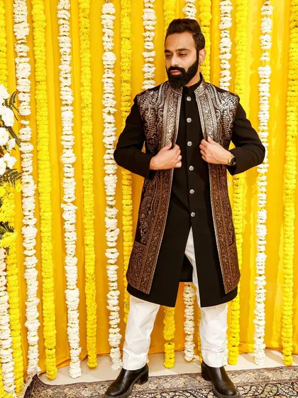 Make an impression at your friend's wedding with this black Indo-Western outfit, featuring a long jacket with stunning gold embroidery. It's a look that is both powerful and elegant.
